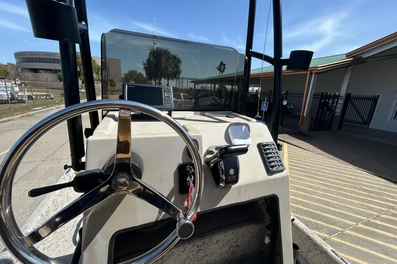 Slide: The Image of Steering console of 2015 Shallow Stalker Cat 240 Pro boat with controls and display. - 9