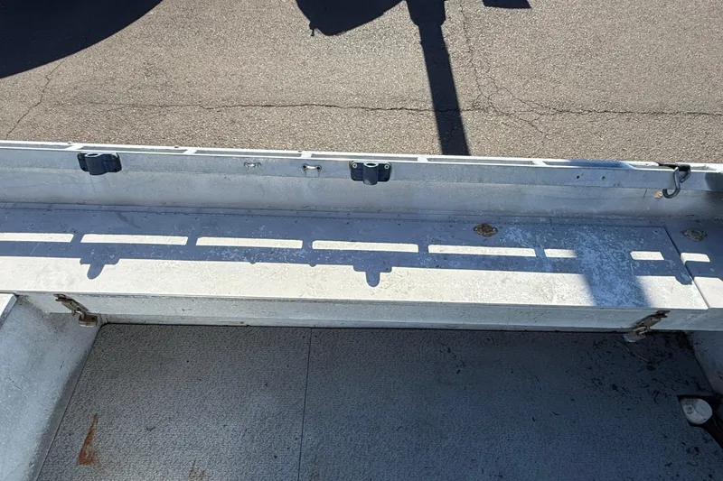 Slide: The Image of 1983 Alumaweld Center Console boat interior with metal bench and shadowed surface. - 10