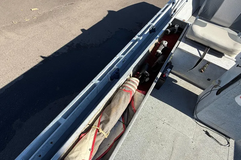 Slide: The Image of 1983 Alumaweld Center Console boat interior with storage compartment and seating. - 11