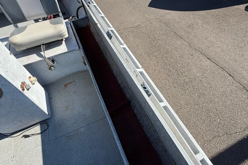 Slide: The Image of 1983 Alumaweld Center Console boat interior with seating and storage compartments. - 12