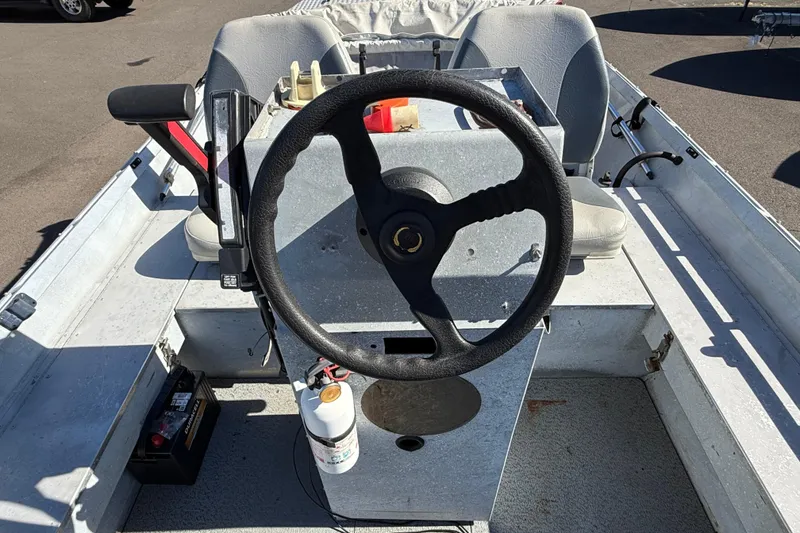 Slide: The Image of 1983 Alumaweld Center Console boat interior with steering wheel and seating. - 13
