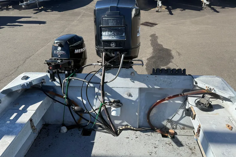 Slide: The Image of 1983 Alumaweld Center Console boat with Mercury outboard motors, showing wiring and engine setup. - 15