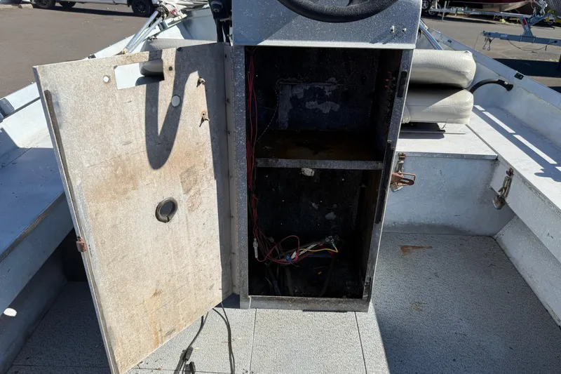 Slide: The Image of 1983 Alumaweld Center Console interior with open storage compartment and visible wiring. - 20