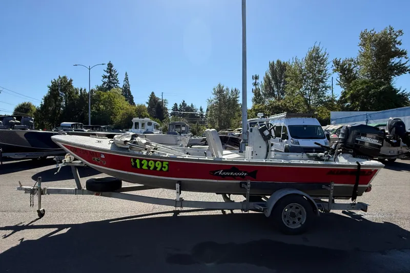 Slide: The Image of 1983 Alumaweld Center Console boat on trailer, priced at $12,995, in outdoor setting. - 3