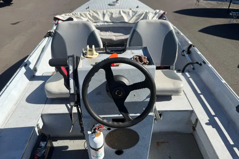 Slide: The Image of 1983 Alumaweld Center Console boat interior with steering wheel and dual seats. - 5