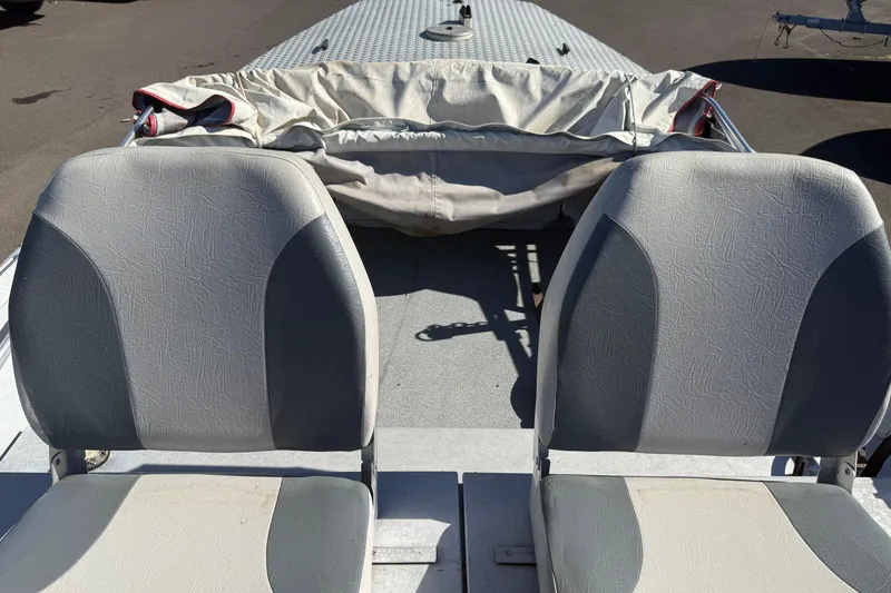 Slide: The Image of 1983 Alumaweld Center Console boat seats with protective cover in sunlight. - 7