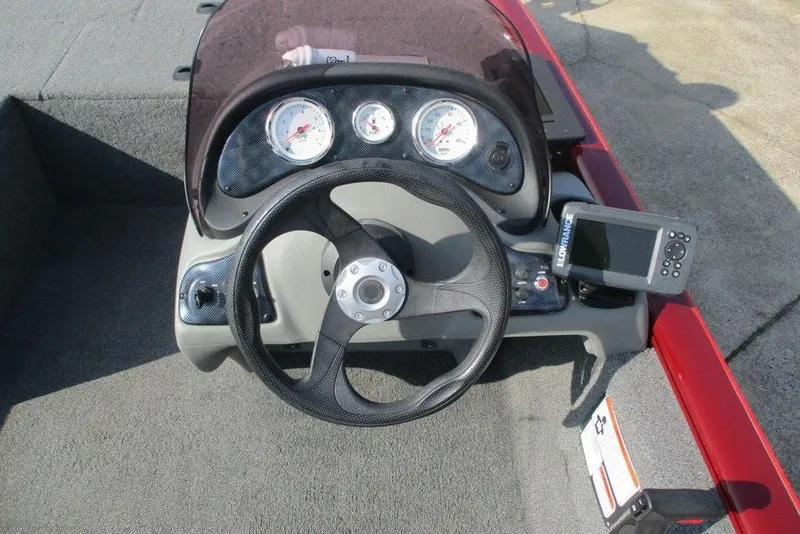 Slide: The Image of 2018 Tracker Pro 170 boat dashboard with steering wheel and gauges. - 6