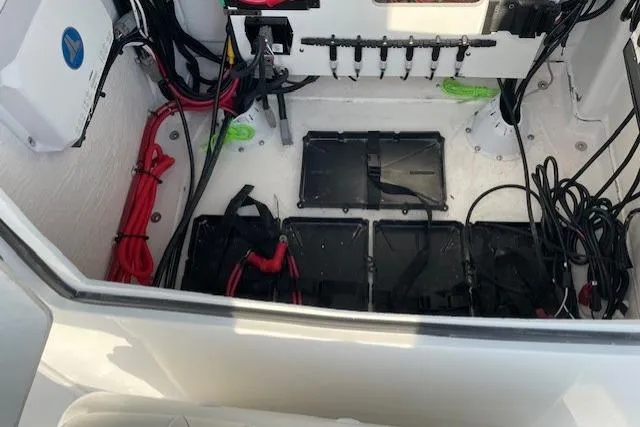 Slide: The Image of Electrical compartment of 2026 Blazer Bay 2440 boat with wiring and battery setup. - 10