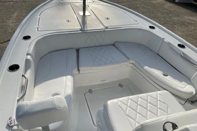 Slide: The Image of 2026 Blazer Bay 2440 boat interior with white cushioned seating and storage compartments. - 12
