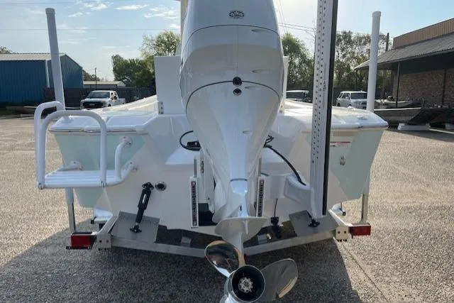 Slide: The Image of 2026 Blazer Bay 2440 boat rear view with outboard motor in parking lot. - 15