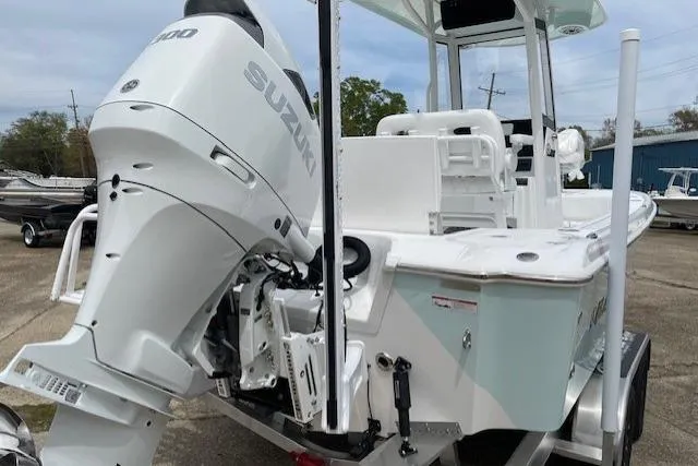 Slide: The Image of 2026 Blazer Bay 2440 boat with Suzuki outboard motor, parked outdoors. - 3