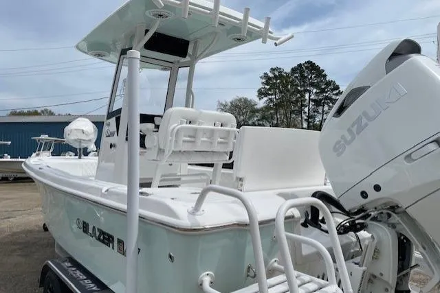 Slide: The Image of 2026 Blazer Bay 2440 boat with Suzuki engine, docked outdoors. - 4
