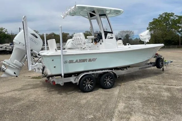 Slide: The Image of 2026 Blazer Bay 2440 boat on trailer with Suzuki outboard motor. - 5