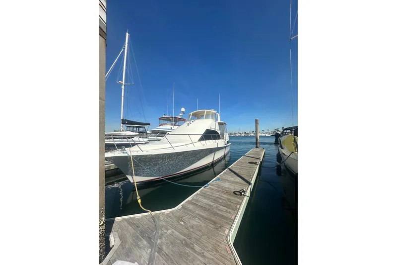The Image of 1994 Oceans motor yacht docked at marina under clear blue sky. - 1