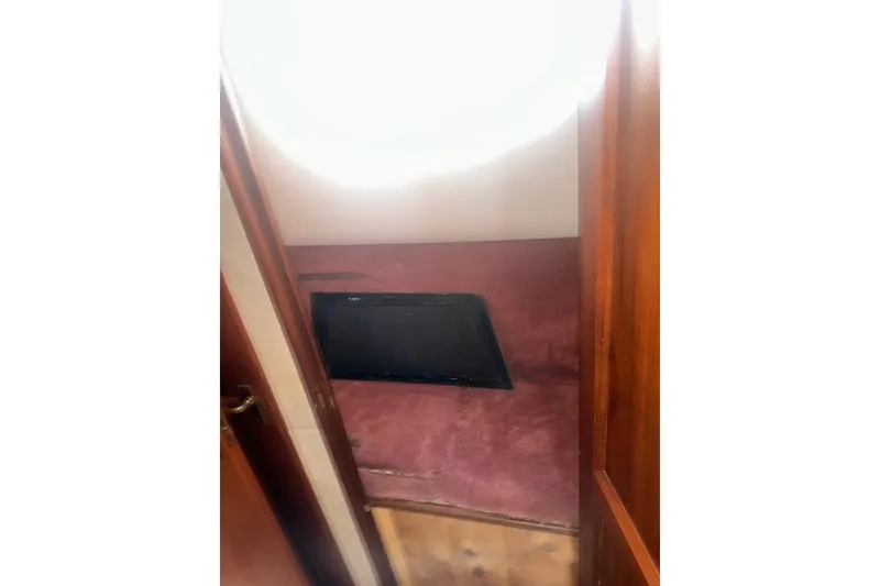 Slide: The Image of Interior cabin of 1994 Oceans motor yacht with maroon upholstery and wooden accents. - 10