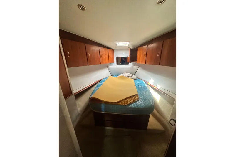 Slide: The Image of Cozy cabin interior of 1994 Oceans motor yacht with wooden cabinets and bed. - 16