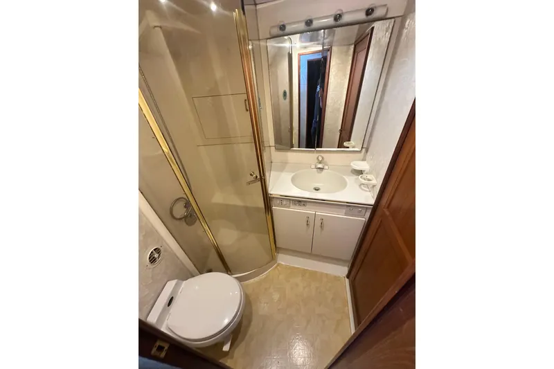 Slide: The Image of Luxurious 1994 Oceans motor yacht bathroom with shower, vanity, and toilet. - 17