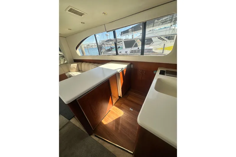Slide: The Image of Interior of a 1994 Oceans motor yacht with wooden cabinetry and large window view. - 18