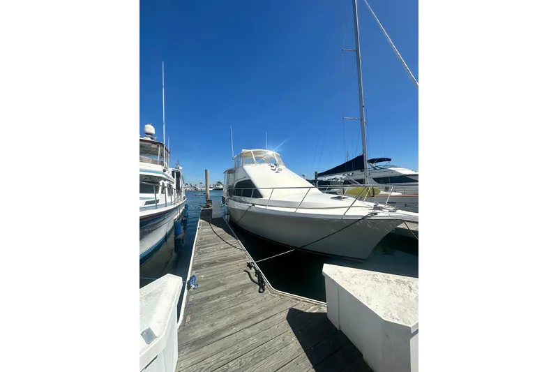 Slide: The Image of 1994 Oceans motor yacht docked at marina under clear blue sky. - 2