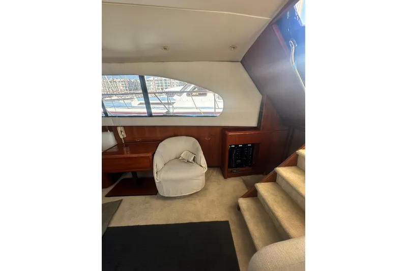 Slide: The Image of Interior of 1994 Oceans motor yacht with chair, stairs, and window view. - 20