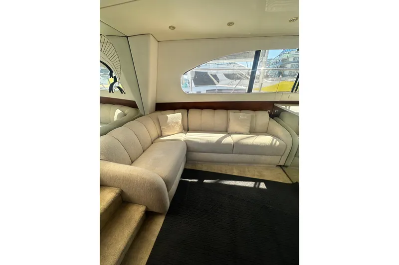 Slide: The Image of Luxurious interior of a 1994 Oceans motor yacht with plush beige seating. - 21