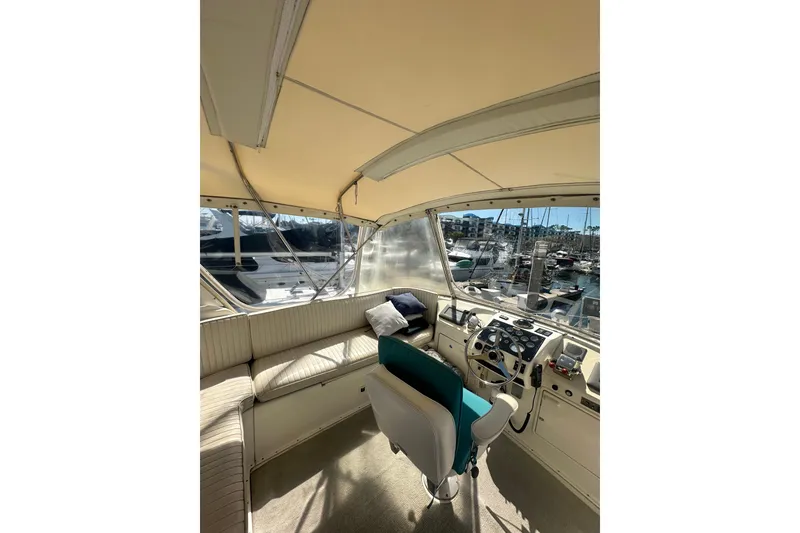 Slide: The Image of 1994 Oceans motor yacht interior with helm, seating, and marina view. - 23