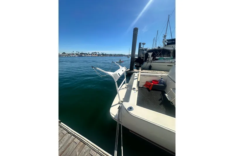 Slide: The Image of 1994 Oceans motor yacht docked at marina, clear blue sky, calm water. - 29