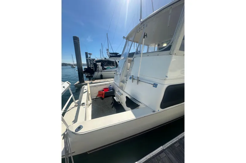 Slide: The Image of 1994 Oceans motor yacht docked at marina under clear blue sky. - 30