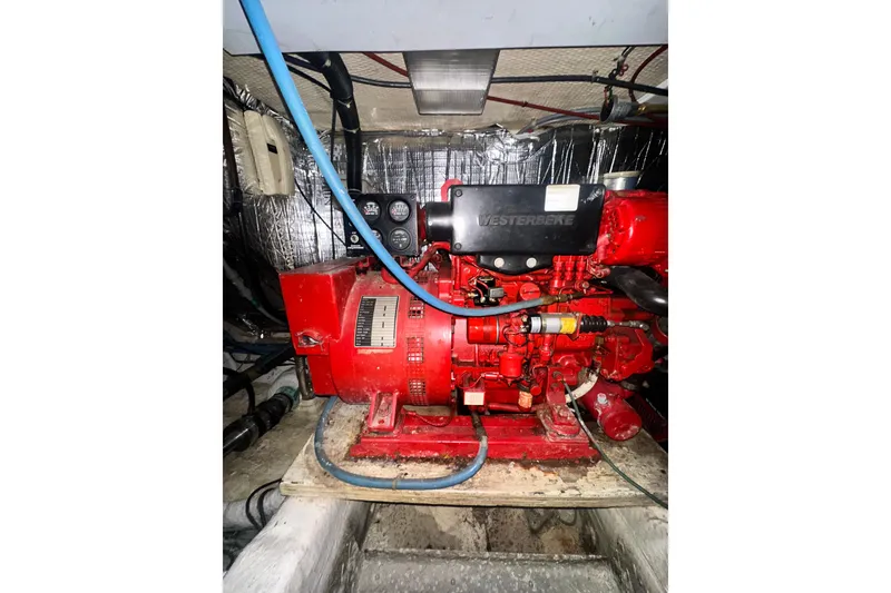 Slide: The Image of Engine room of a 1994 Oceans motor yacht featuring a red Westerbeke generator. - 7