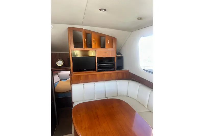 Slide: The Image of Luxurious 1994 Oceans motor yacht interior with wood cabinetry and white seating. - 9