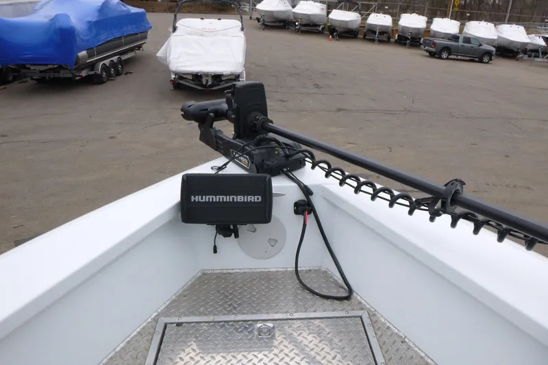 Slide: The Image of 2025 Hewescraft 240 Ocean Pro boat with Humminbird equipment, parked among covered boats. - 11