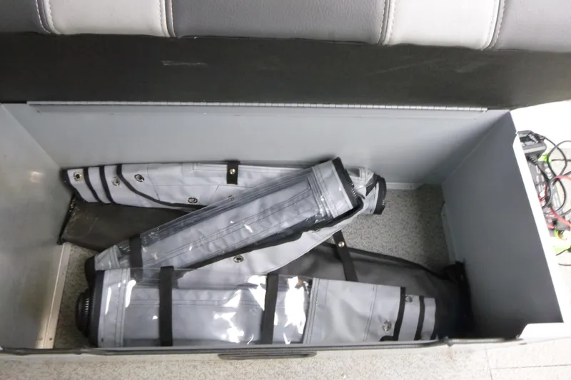 Slide: The Image of Storage compartment in 2025 Hewescraft 240 Ocean Pro boat with rolled-up covers. - 18