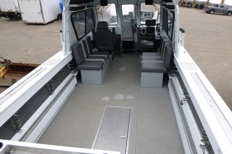 Slide: The Image of 2025 Hewescraft 240 Ocean Pro interior with seating and steering console. - 5