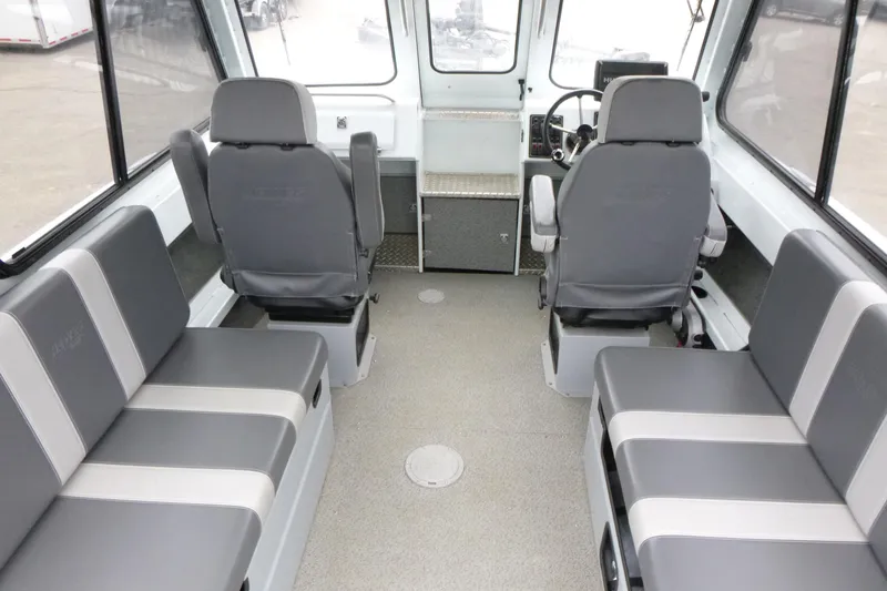 Slide: The Image of Interior of 2025 Hewescraft 240 Ocean Pro boat with gray seating and steering console. - 7