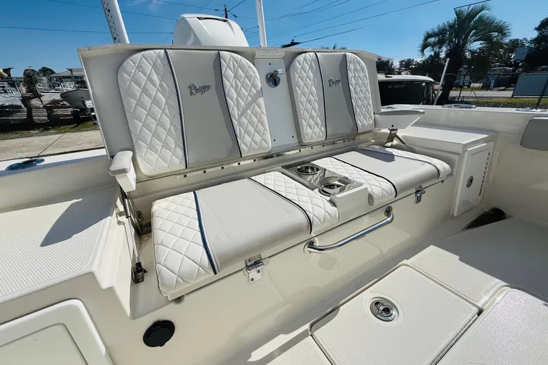 Slide: The Image of 2022 Ranger 2660 Bay boat interior with quilted seating and cup holders. - 11