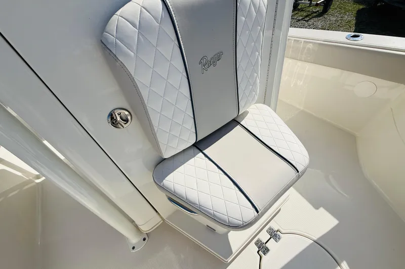 Slide: The Image of White cushioned seat on 2022 Ranger 2660 Bay boat, featuring diamond stitching. - 12