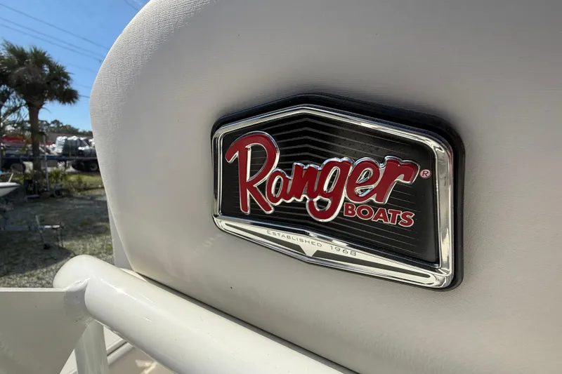 Slide: The Image of Ranger Boats logo on a 2022 Ranger 2660 Bay, outdoor setting. - 16