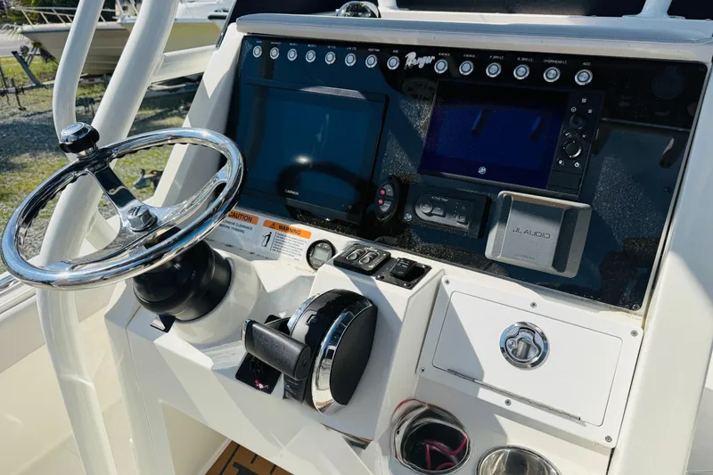 Slide: The Image of 2022 Ranger 2660 Bay boat dashboard with steering wheel and electronic controls. - 6