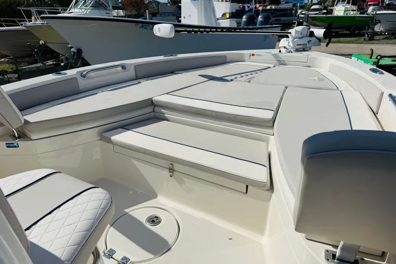 Slide: The Image of 2022 Ranger 2660 Bay boat interior with cushioned seating and storage compartments. - 7