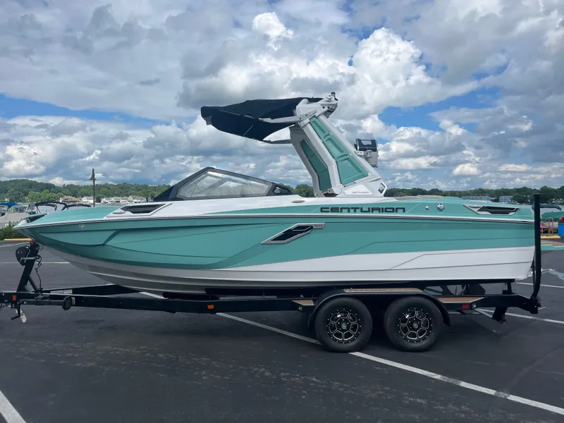 The Image of 2024 Centurion Ri230 boat on trailer under cloudy sky. - 0