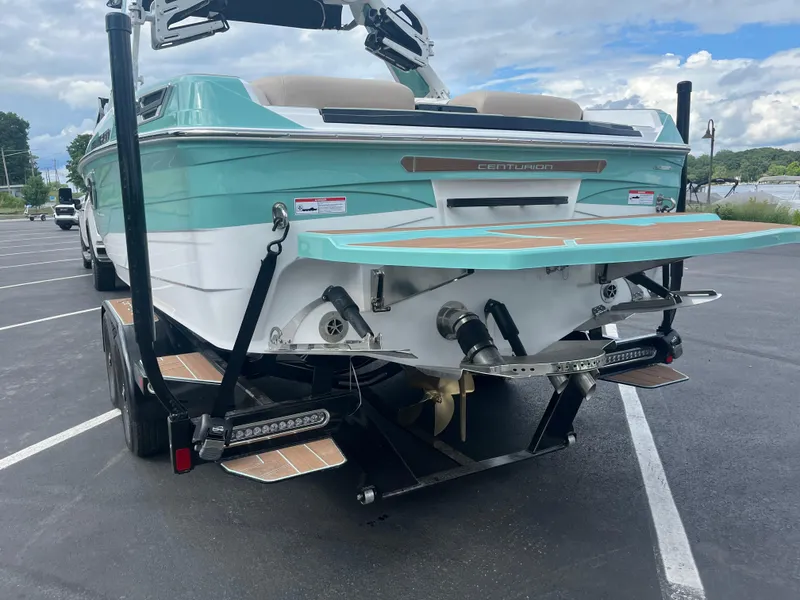 Slide: The Image of 2024 Centurion Ri230 boat parked on trailer outdoors. - 10