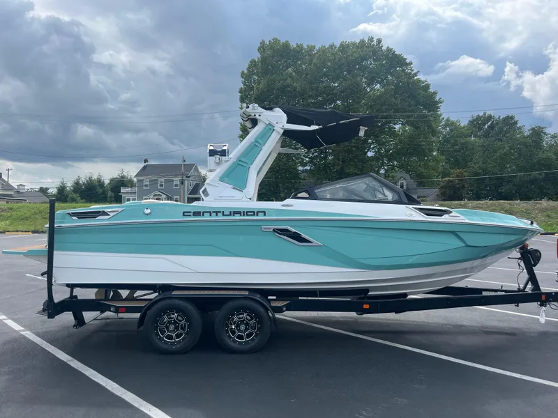 Slide: The Image of 2024 Centurion Ri230 boat on trailer, turquoise and white. - 12