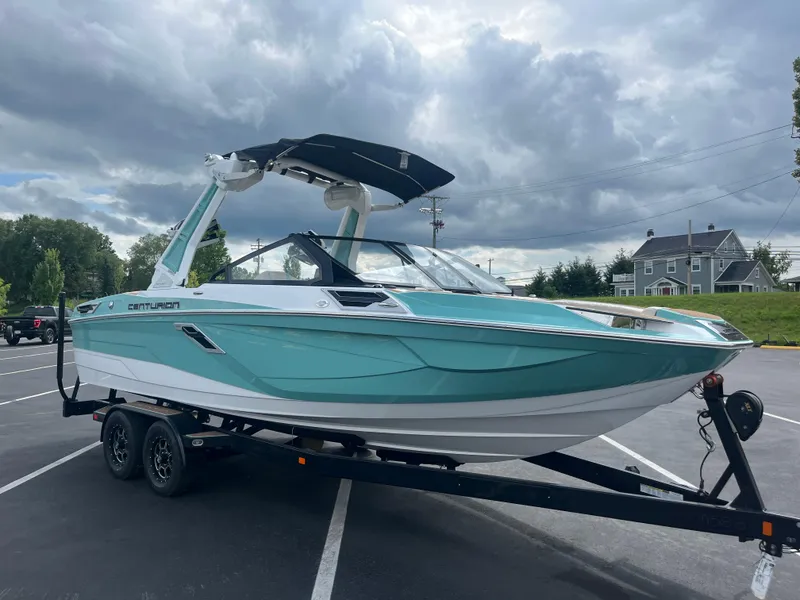 Slide: The Image of 2024 Centurion Ri230 boat on trailer, cloudy sky. - 13