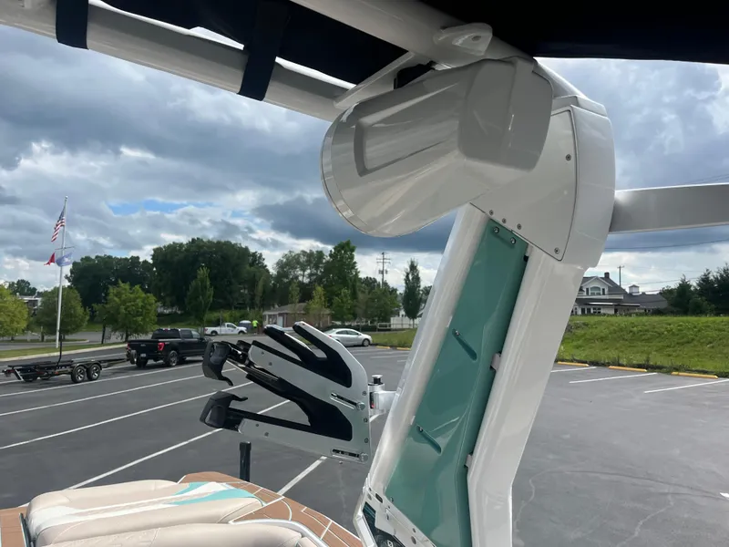 Slide: The Image of 2024 Centurion Ri230 boat with modern features parked outdoors. - 4