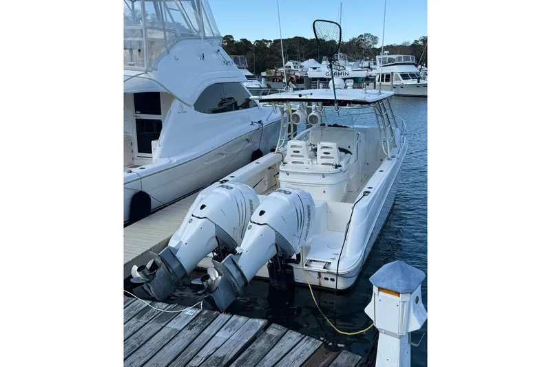 Slide: The Image of 2007 Boston Whaler 320 Outrage Cuddy Cabin docked with twin outboard engines. - 1