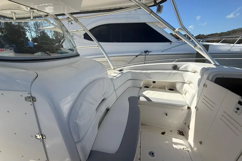 Slide: The Image of 2007 Boston Whaler 320 Outrage Cuddy Cabin interior with white seating and helm. - 10