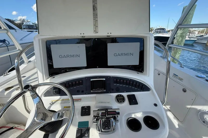Slide: The Image of 2007 Boston Whaler 320 Outrage Cuddy Cabin helm with Garmin navigation displays. - 11