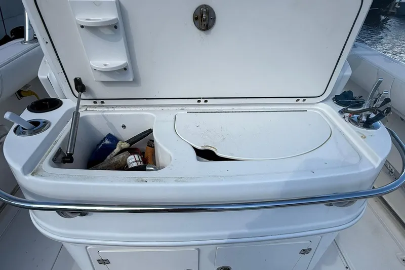 Slide: The Image of Open storage compartment on a 2007 Boston Whaler 320 Outrage Cuddy Cabin boat. - 14