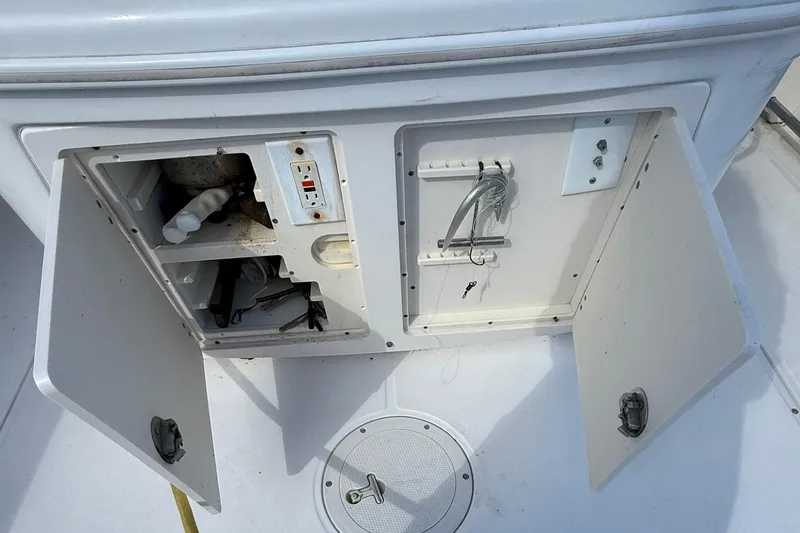 Slide: The Image of Open storage compartments on a 2007 Boston Whaler 320 Outrage Cuddy Cabin boat. - 15