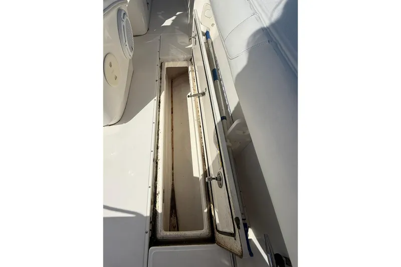 Slide: The Image of Open storage compartment on 2007 Boston Whaler 320 Outrage Cuddy Cabin boat. - 17